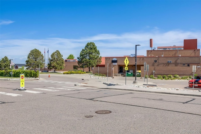 19294 E Warren Pl, Aurora, CO 80013 - view of asphalt street with traffic signs, curbs, and sidewalks
