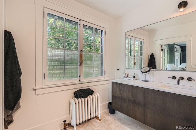 785 Fillmore St, Denver, CO 80206 - full bathroom with radiator heating unit, double vanity, and baseboards