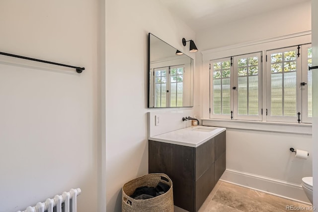 785 Fillmore St, Denver, CO 80206 - bathroom featuring radiator heating unit, toilet, vanity, and baseboards