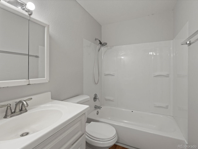 bathroom featuring toilet, bathtub / shower combination, and vanity