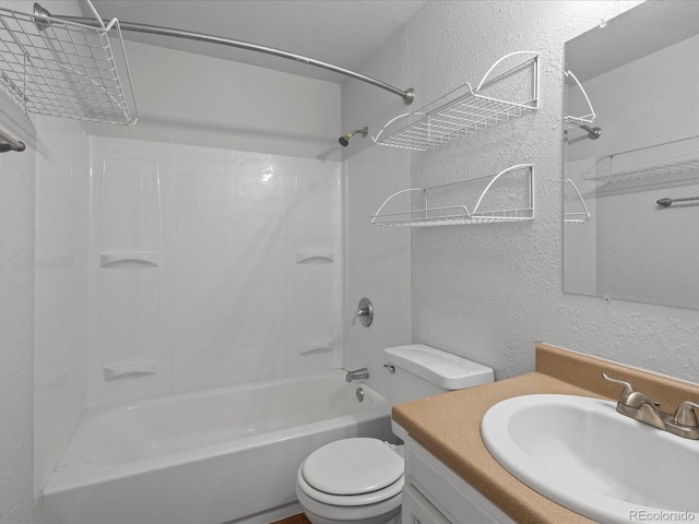 full bathroom featuring washtub / shower combination, a textured wall, vanity, and toilet