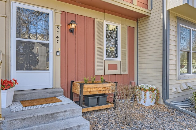 doorway to property featuring board and batten siding