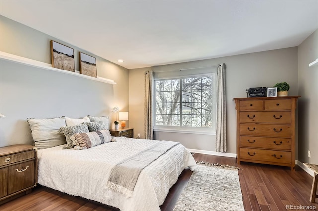 bedroom with dark wood-style floors and baseboards