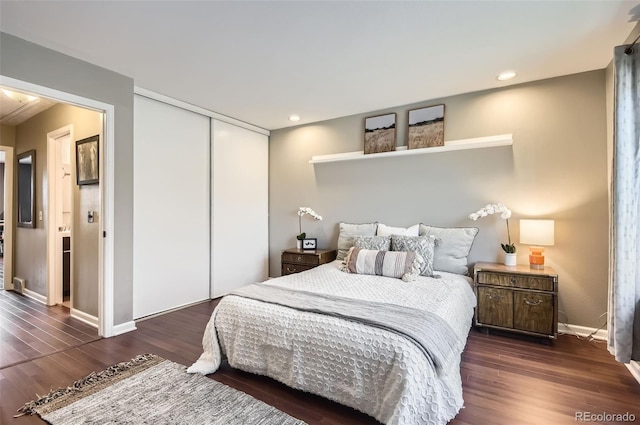 bedroom with recessed lighting, a closet, baseboards, and wood finished floors