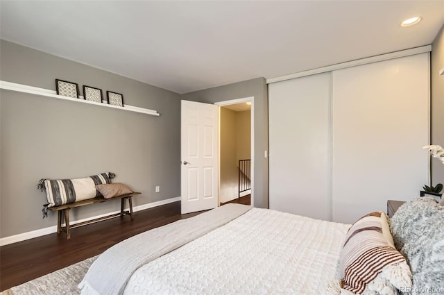 bedroom featuring a closet, baseboards, dark wood-type flooring, and recessed lighting