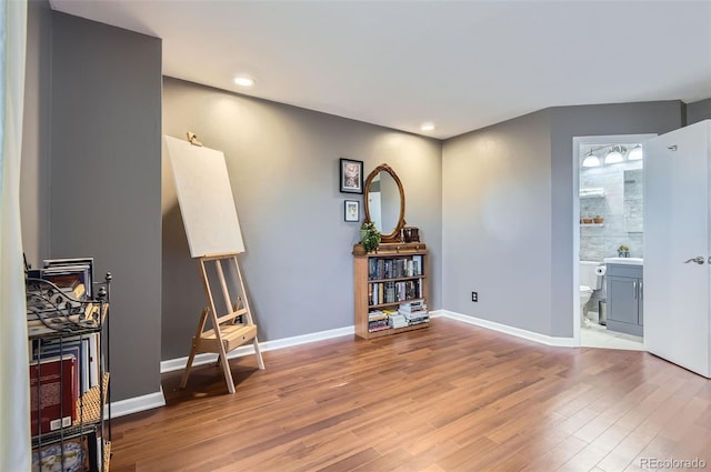 interior space featuring recessed lighting, baseboards, and wood finished floors