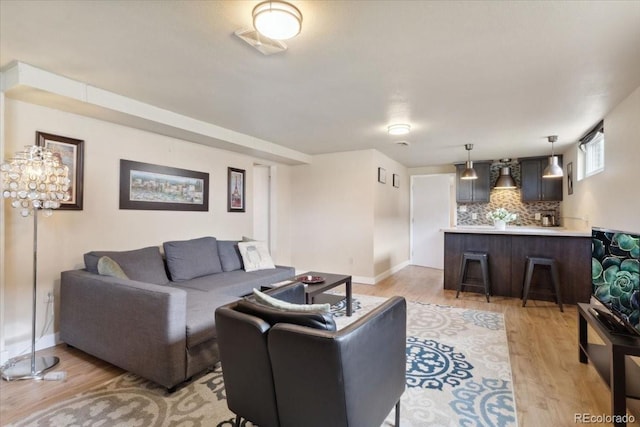 5185 N Meade St, Denver, CO 80221 - living area featuring light wood-type flooring and baseboards