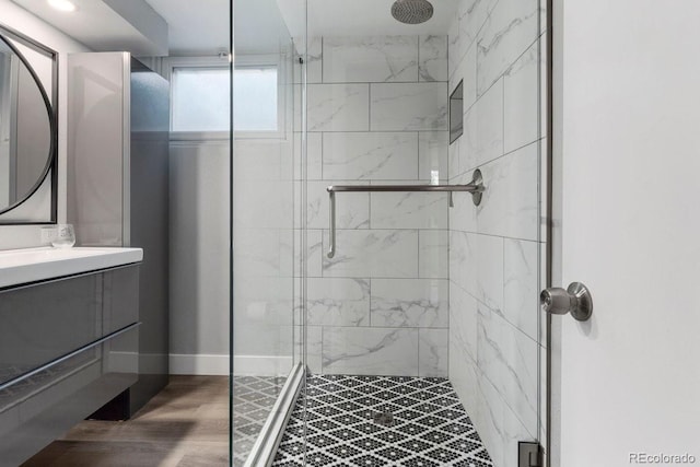 5185 N Meade St, Denver, CO 80221 - bathroom featuring a shower stall, vanity, and wood finished floors
