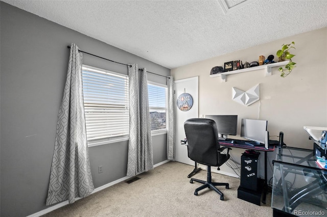 carpeted home office with a textured ceiling