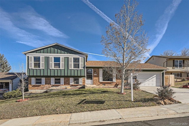 split level home with a garage and a front yard