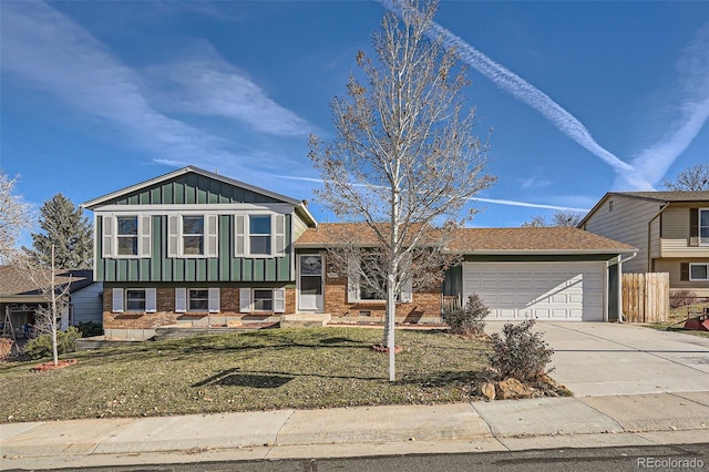 tri-level home with a front lawn and a garage