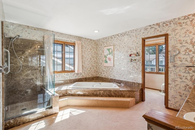bathroom featuring a stall shower, a garden tub, wallpapered walls, and plenty of natural light