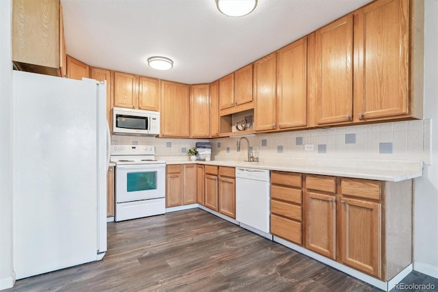 kitchen featuring a sink, decorative backsplash, white appliances, and light countertops