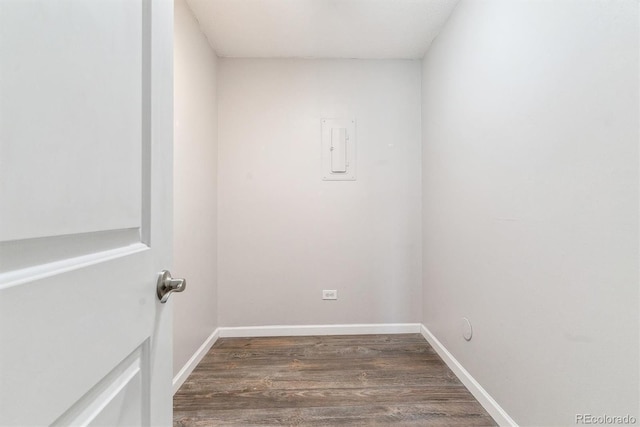 unfurnished room with baseboards and wood finished floors