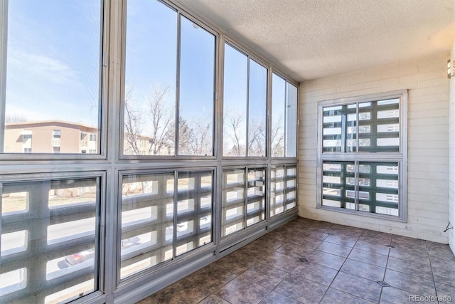 unfurnished sunroom with a wealth of natural light