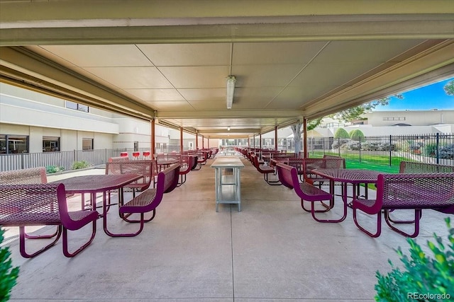 view of patio featuring outdoor dining area and fence