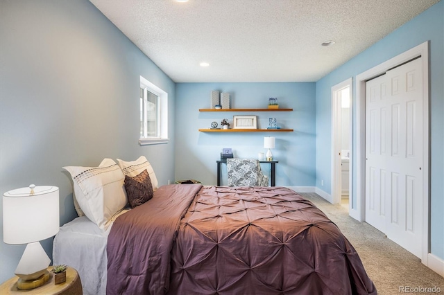 bedroom with multiple windows, light carpet, and a textured ceiling