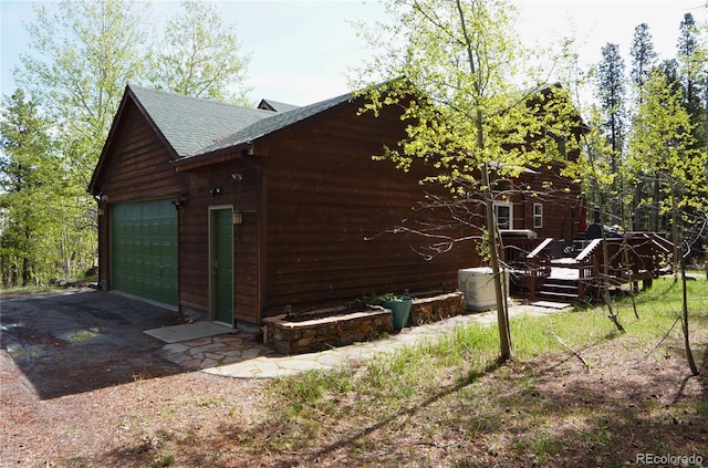 116 Timber Rd, Black Hawk, CO 80422 - view of home's exterior with a shingled roof and a detached garage