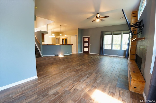 116 Timber Rd, Black Hawk, CO 80422 - unfurnished living room featuring ceiling fan, a fireplace, dark wood-style floors, and stairs