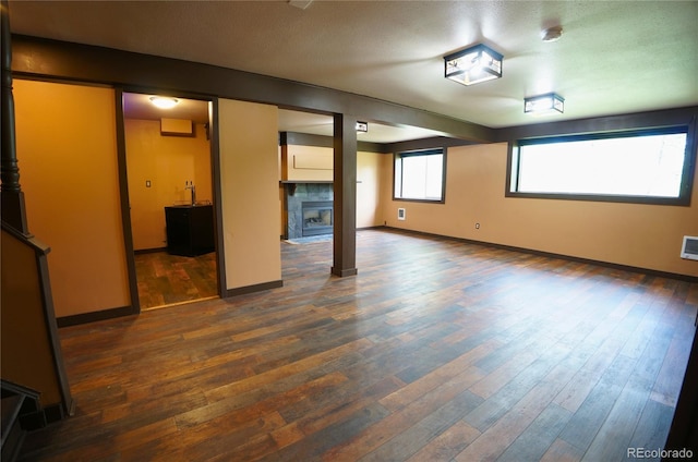 116 Timber Rd, Black Hawk, CO 80422 - unfurnished room featuring dark wood finished floors and a tile fireplace
