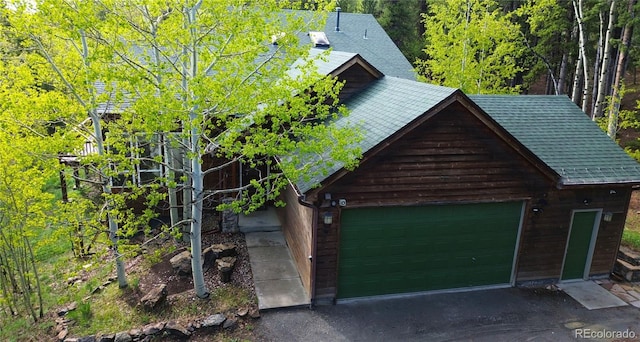116 Timber Rd, Black Hawk, CO 80422 - view of front of property with a garage, a shingled roof, and a forest view