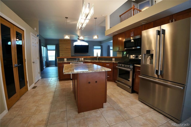 116 Timber Rd, Black Hawk, CO 80422 - kitchen featuring appliances with stainless steel finishes, healthy amount of natural light, a center island, and light tile patterned floors