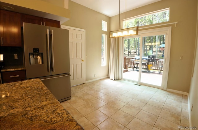 116 Timber Rd, Black Hawk, CO 80422 - kitchen featuring stainless steel refrigerator with ice dispenser, light tile patterned flooring, pendant lighting, and dark stone counters