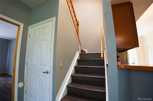 116 Timber Rd, Black Hawk, CO 80422 - staircase featuring wood finished floors and baseboards