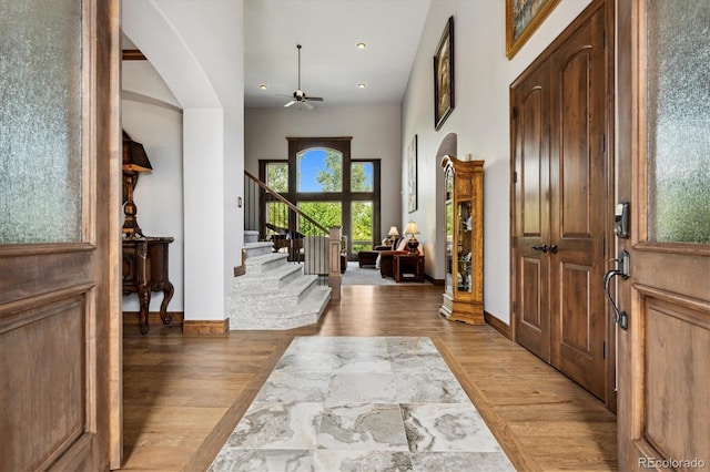 foyer entrance with ceiling fan and hardwood / wood-style flooring