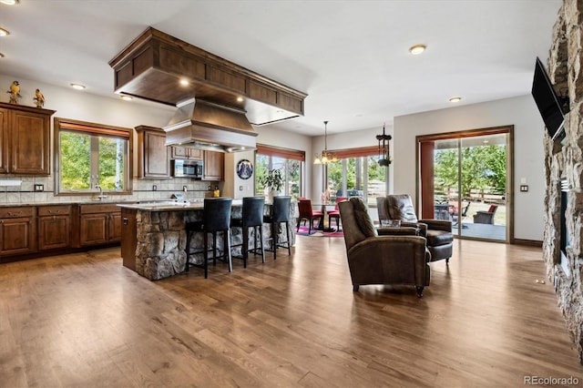 kitchen featuring a wealth of natural light, a kitchen island, and a stone fireplace