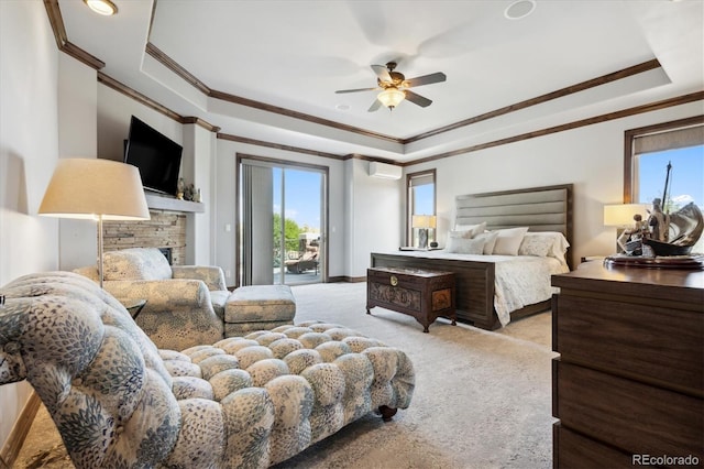 bedroom featuring a raised ceiling, a fireplace, ceiling fan, access to outside, and a wall mounted AC