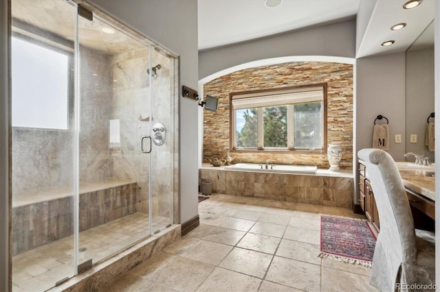 bathroom featuring shower with separate bathtub and vanity