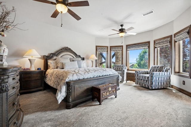 carpeted bedroom featuring ceiling fan and multiple windows