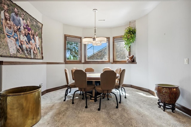 dining space featuring an inviting chandelier