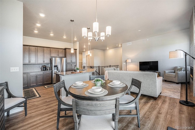 811 W 128th Pl, Westminster, CO 80234 - dining room featuring a chandelier, wood finished floors, and recessed lighting