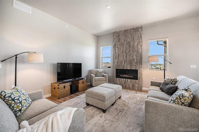 811 W 128th Pl, Westminster, CO 80234 - living area featuring wood finished floors and a tiled fireplace