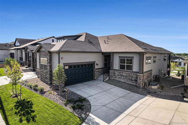 811 W 128th Pl, Westminster, CO 80234 - view of front of house with stone siding, a garage, driveway, and roof with shingles