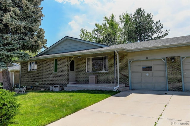 10560 W 63rd Ave, Arvada, CO 80004 - single story home with a front yard, concrete driveway, brick siding, and an attached garage