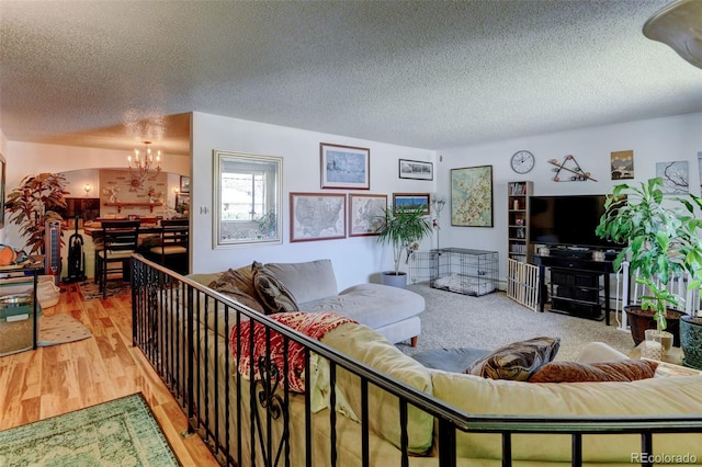 10560 W 63rd Ave, Arvada, CO 80004 - living area featuring a chandelier, a textured ceiling, and wood finished floors