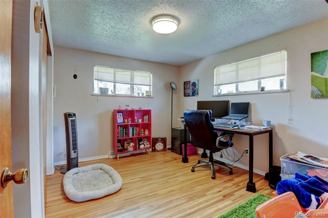 10560 W 63rd Ave, Arvada, CO 80004 - office with plenty of natural light, a textured ceiling, wood finished floors, and baseboards