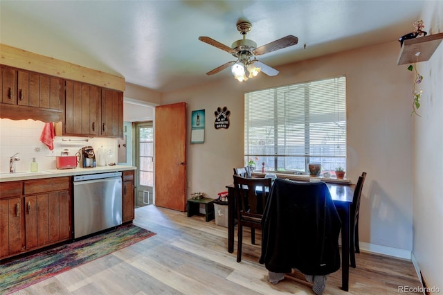 10560 W 63rd Ave, Arvada, CO 80004 - kitchen with dishwasher, a sink, backsplash, ceiling fan, and light countertops
