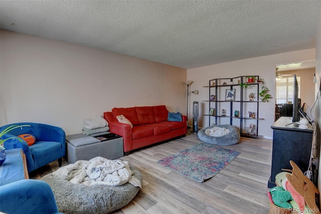 10560 W 63rd Ave, Arvada, CO 80004 - living room with wood finished floors, a textured ceiling, and ceiling fan