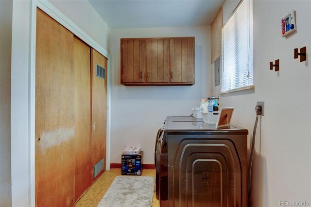 10560 W 63rd Ave, Arvada, CO 80004 - clothes washing area featuring washing machine and clothes dryer, cabinet space, and baseboards