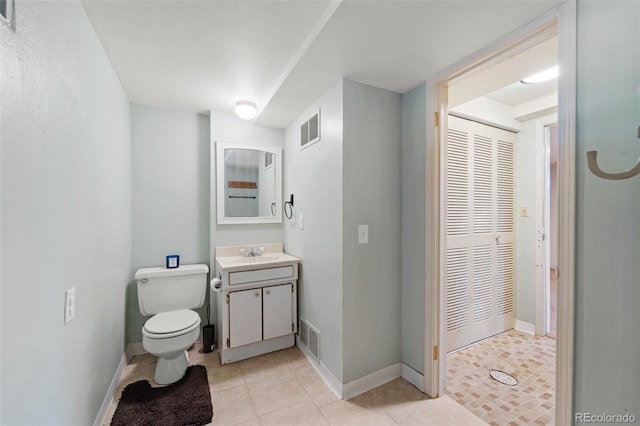 bathroom with tile patterned floors, vanity, and toilet