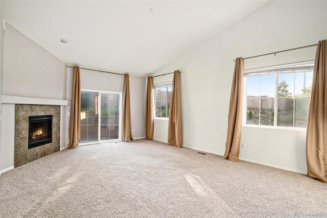 unfurnished living room with a fireplace, visible vents, baseboards, vaulted ceiling, and carpet