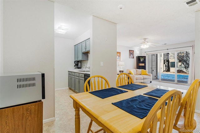 dining area with sink, ceiling fan, and heating unit