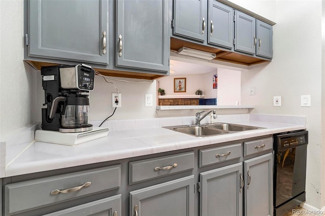 kitchen with sink, dishwasher, and gray cabinetry