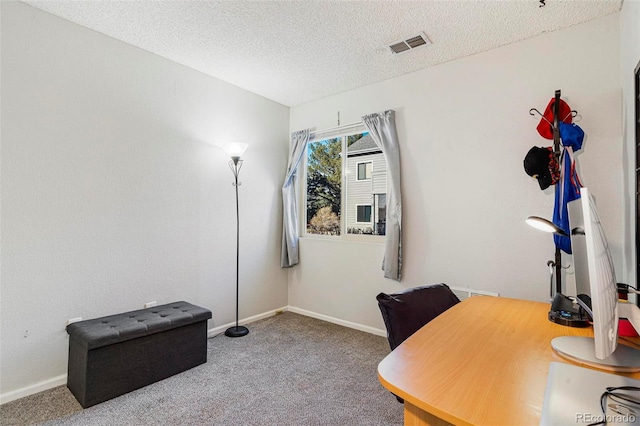 home office featuring a textured ceiling and carpet