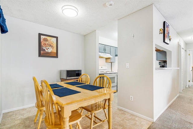 dining area featuring a textured ceiling