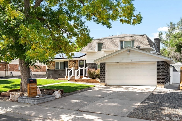 view of front of home with a front yard and solar panels